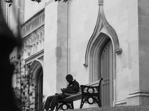 sitting on bench near church